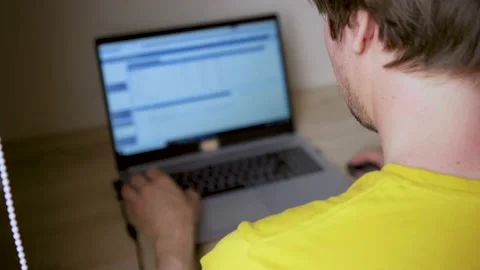 A man uses a laptop for distant work on a project. Work from home concept Stock Footage 157724435