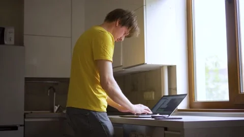 A man uses a laptop for distant work on a project. Work from home concept Stock Footage 157724703
