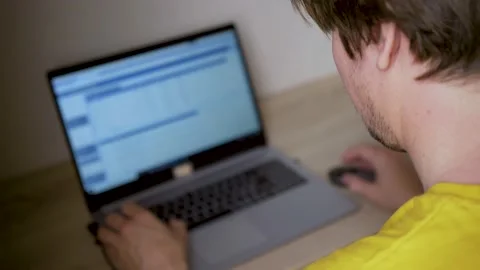 A man uses a laptop for distant work on a project. Work from home concept Stock Footage 157731777