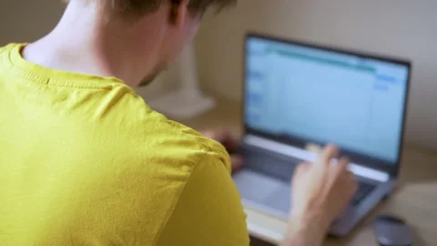 A man uses a laptop for distant work on a project. Work from home concept Stock Footage 157928086