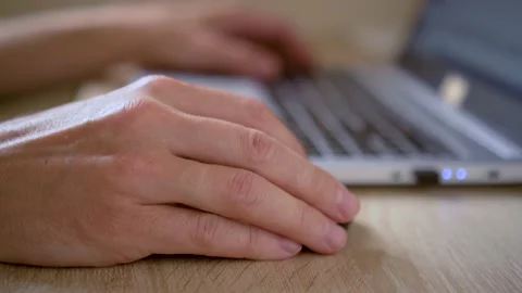 A man uses a laptop for distant work on a project. Work from home concept Stock Footage 157928234