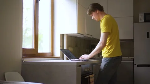A man uses a laptop for distant work on a project. Work from home concept Stock Footage 157928292