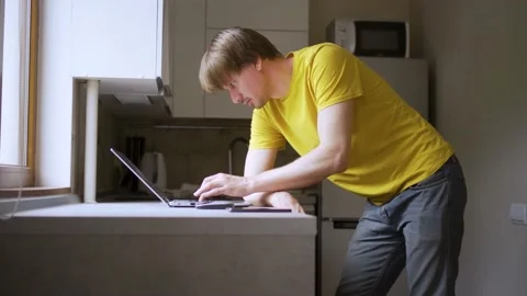 A man uses a laptop for distant work on a project. Work from home concept Stock Footage 158218773