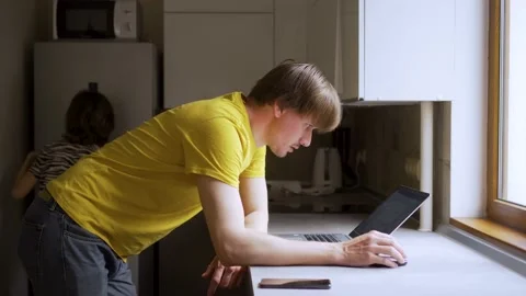 A man uses a laptop for distant work on a project. Work from home concept Stock Footage 158548887