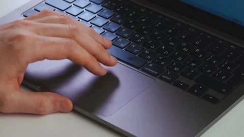 A man uses a laptop touchpad Stock Footage 176889101