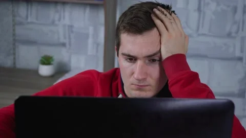 A man uses a laptop while sitting in the room Stock Footage 145123390