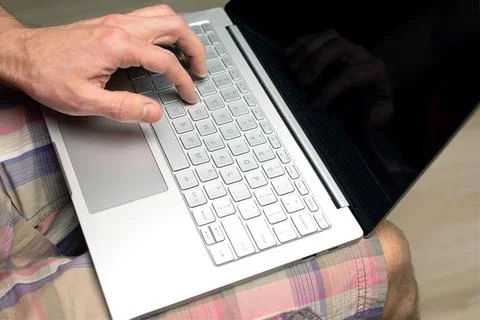 Man uses laptop while sitting at home. Online shopping concept, online games Stock Photos