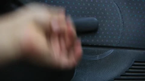 A man uses a lever to crank the window down, after twenty years the lever leaves Stock Footage 254600919