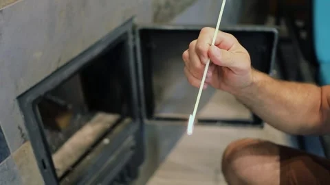 Man uses long burning match to ignite stove with glass lid. Slow motion Stock Footage 276376318