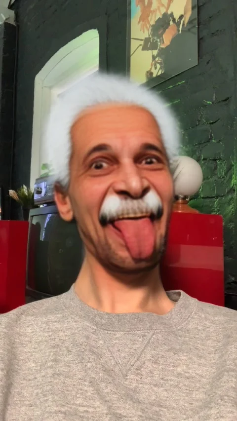 Man uses mask with face of Albert Einstein in augmented reality app Snapchat.  스톡 동영상 236858650