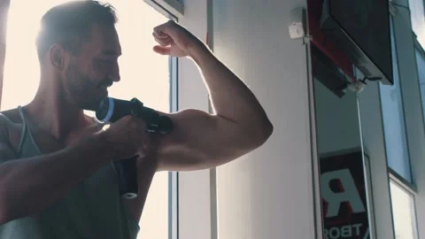 Man uses massager for arm close up Stock Footage 144584224