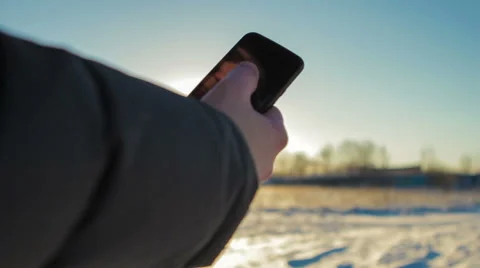 Man Uses a Mobile Phone on a Winter Day. Video stock 61355402