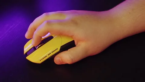 A man uses a mouse, clicks on buttons, plays a game, or works under a neon light Stock Footage 132537919