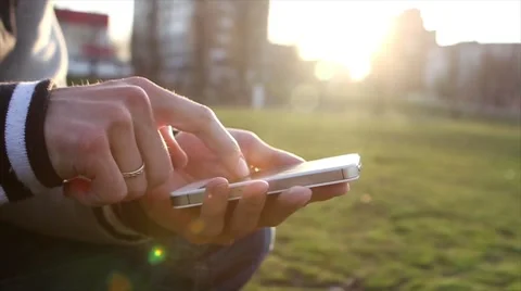 Man Uses The Ohone At a Sunset Background 库存影片 64874029