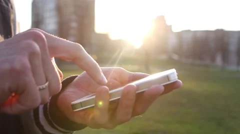 Man Uses The Ohone At a Sunset Background Stock-Footage 64874046