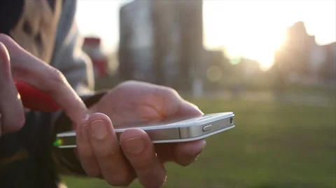 Man Uses The Ohone At a Sunset Background Stock-Footage 64874047