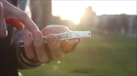 Man Uses The Ohone At a Sunset Background Stock-Footage 64874048