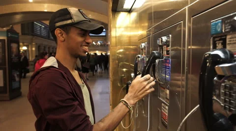 Man uses outdated pay phone. Stock Footage 61387633