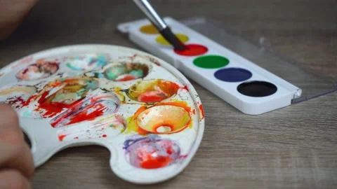 A man uses a palette to thin the paint Video stock 144423931