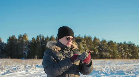 Man Uses Phone on Background of Winter Forest Stock Footage 62284572