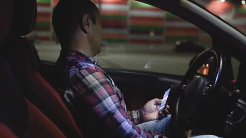 A man uses the phone in the car Stock Footage 95577620