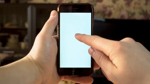 The man uses the phone. A hand makes a double tap with a finger on a smartphone 動画素材 127059778