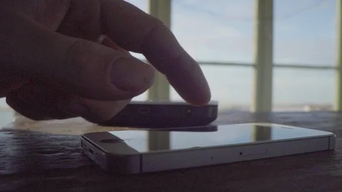 Man uses phone, iphone, in a fire lookout cabin with cell phone wifi Stock Footage 96221833