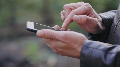 Man uses the phone, scrolls through photos, checks mail. Close-up Stock Footage 95960411