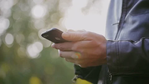 Man uses the phone, scrolls through photos, checks mail, looks at news. Close-up Stock Footage 95960438