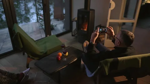 A man uses the phone while sitting in the living room. Stock Footage 265175050