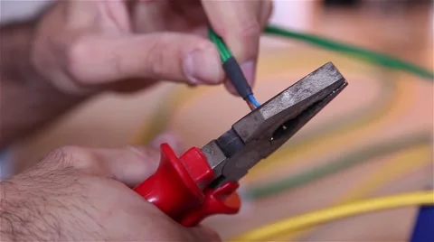 Man uses pliers for stripping electrical wires Stock Footage 56629472