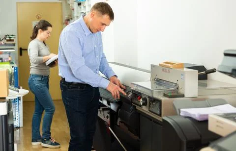 Man uses plotter in small printing shop Fotos de archivo