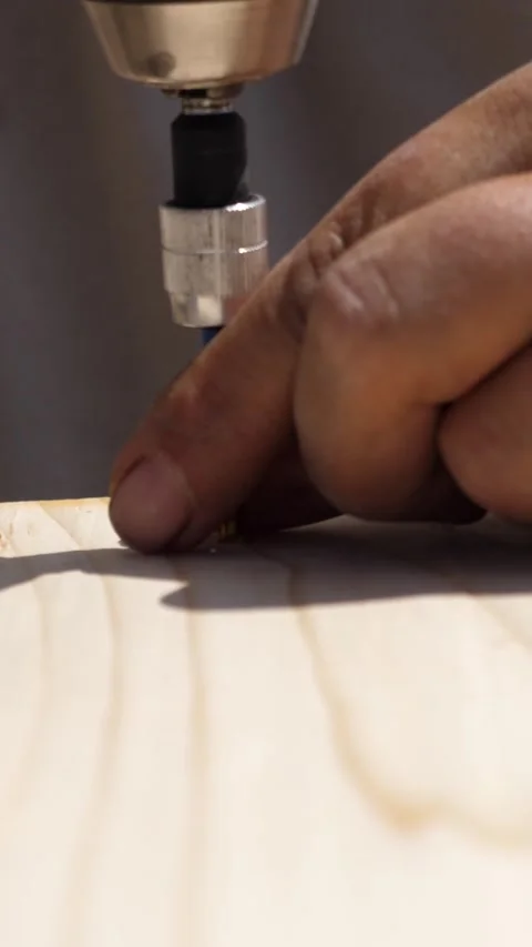 Man uses power drill to drive a long screw into wood Stock Footage 309835006