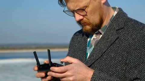 Man uses the remote control for the drone Stock Footage 106914106