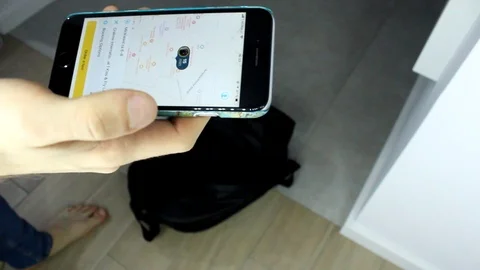 A man uses a ride-sharing app in house phone to call a driver. Stock Footage 86572759