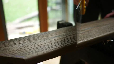 Man uses Saw on Composite Deck Board Vídeo Stock 344826382