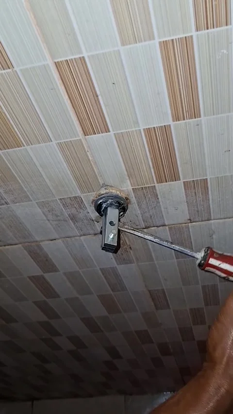 Man uses a screwdriver and an extractor tool to carefully loosen and remove.. Stock Footage 339574899