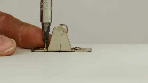 Man uses screwdriver to screw into small clip Video stock 316188029
