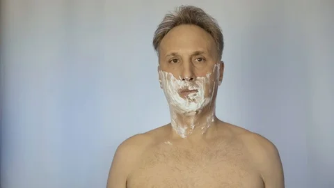 A man uses a sharp razor. He looks after his appearance. Stock-Footage 98173566