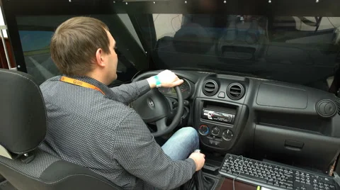 A man uses a simulator of driving of the car. Stock Footage 62691381