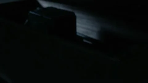 The man uses a small knife to pry open the wooden crate and discovers a radio Stock Footage 276517706