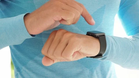 Man uses smart watch app. Sportsman making gestures on a smartwatch. Close-up. Stock Footage 149221076