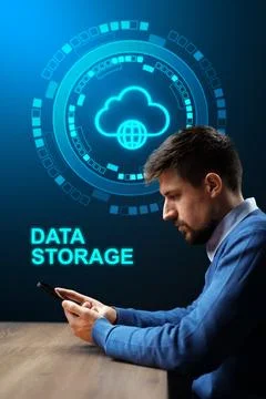 Man uses smartphone to access cloud data storage on a dark background Foto stock
