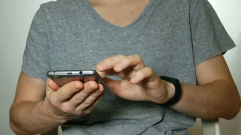 Man uses a smartphone and clock Video stock 91005298