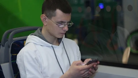 Man uses a smartphone on the bus Stock Footage 87135492
