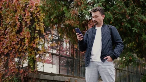 Man uses smartphone Видео 142872388