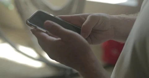 Man uses smartphone at home Stock Footage 78037954