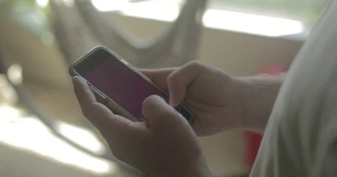 Man uses smartphone at home Stock Footage 78037955