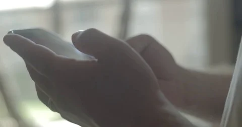 Man uses smartphone at home Stock Footage 78037994