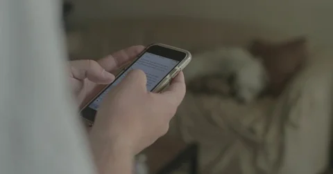 Man uses smartphone at home Stock Footage 78038008
